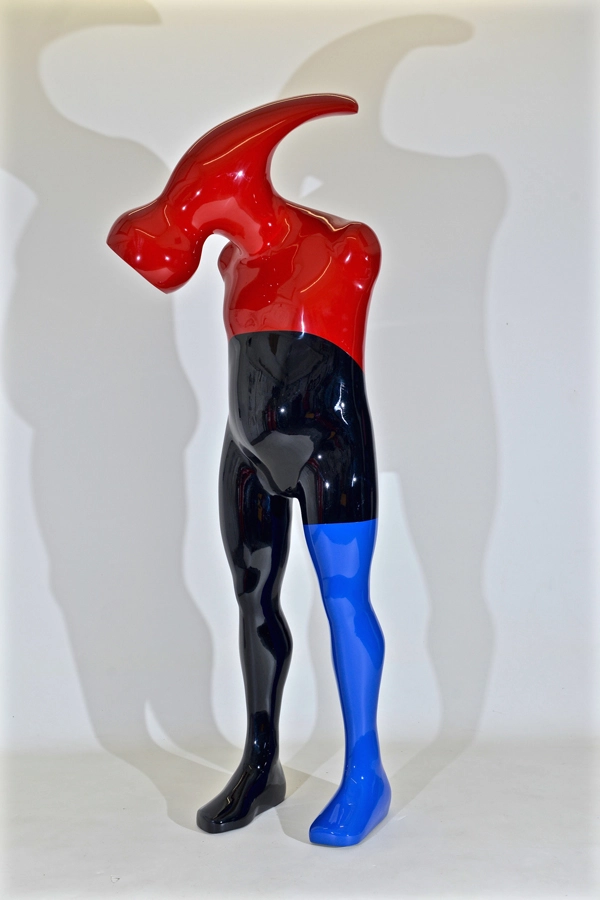 A colorful sculpture featuring red, blue, and black elements, prominently displaying a horn